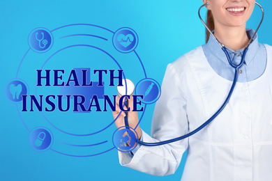 Image of Phrase Health Insurance, icons and doctor with stethoscope on blue background, closeup