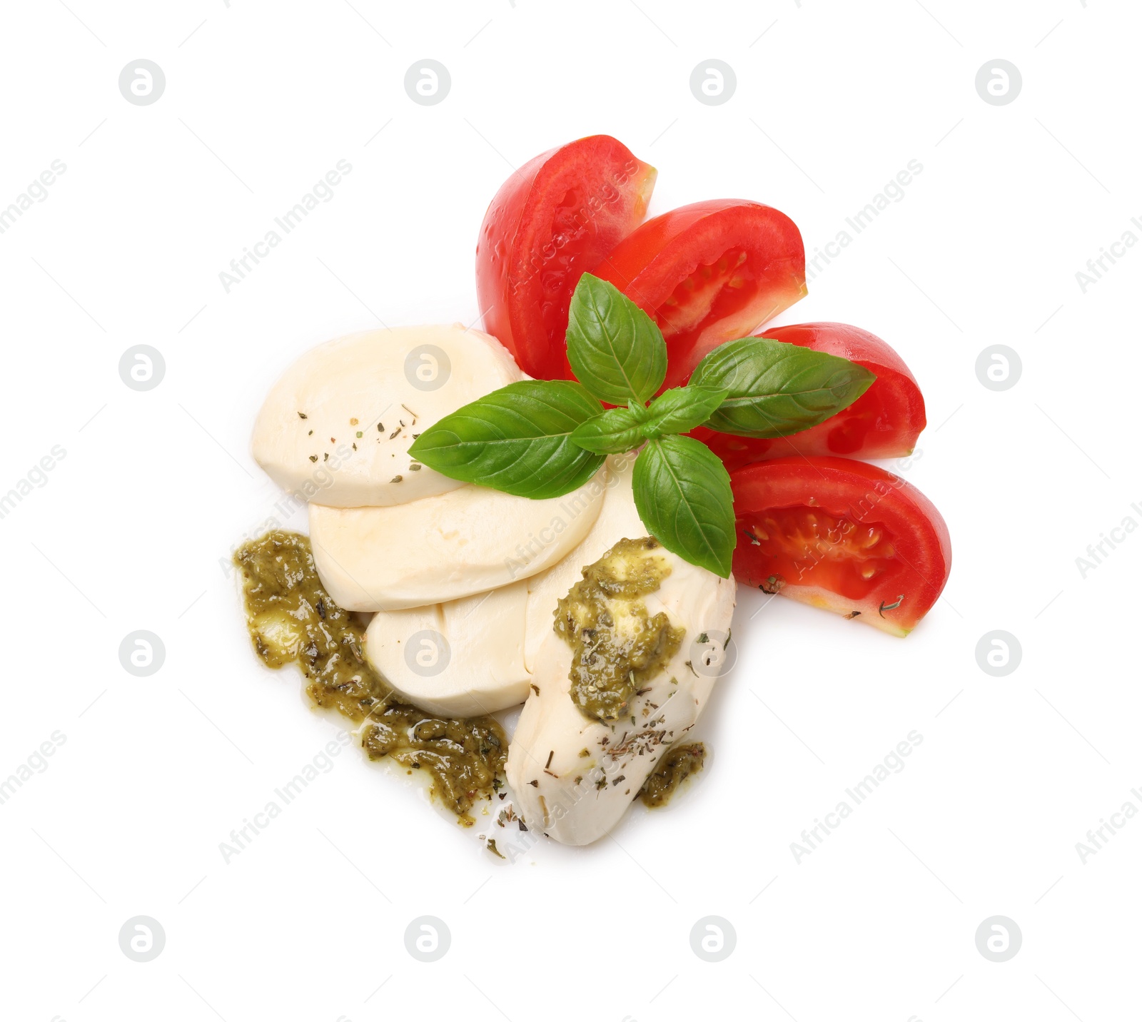 Photo of Tasty salad Caprese with mozzarella, tomatoes, basil and pesto sauce isolated on white, top view