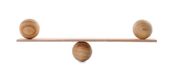 Photo of Small plank with wooden balls on white background. Harmony and balance concept
