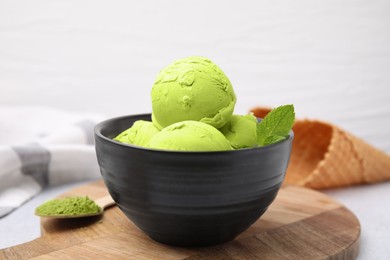 Photo of Tasty matcha ice cream in bowl on table