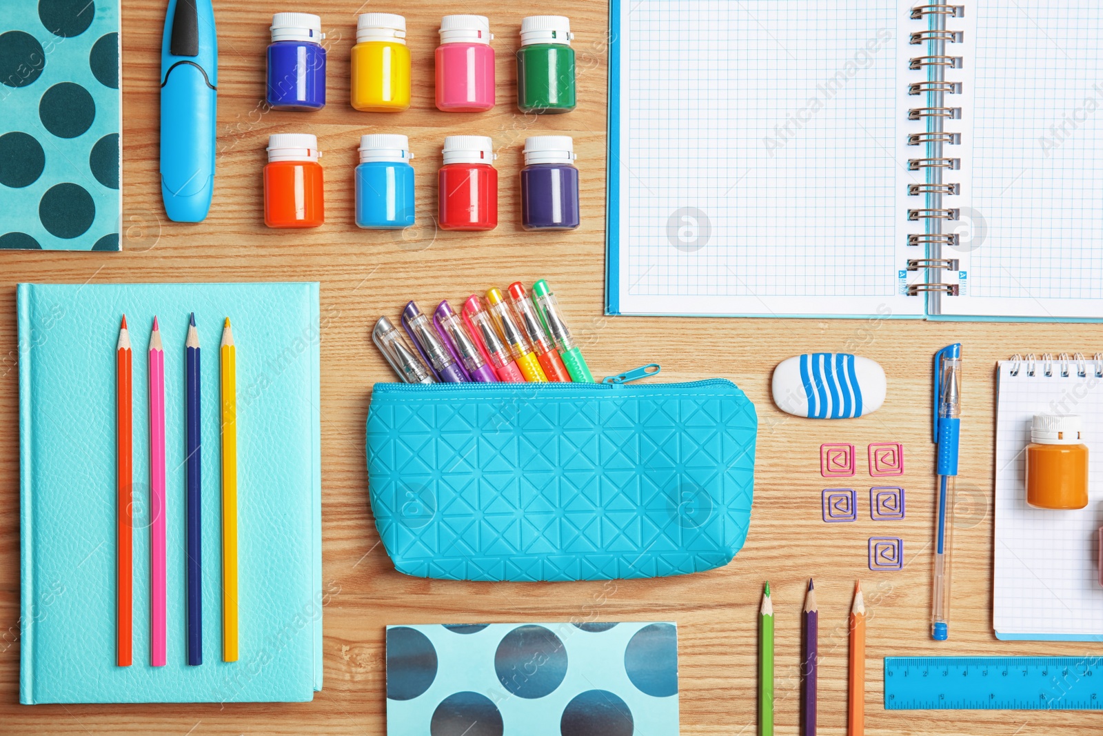 Photo of Different school stationery on wooden background, flat lay