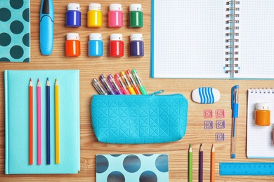 Photo of Different school stationery on wooden background, flat lay