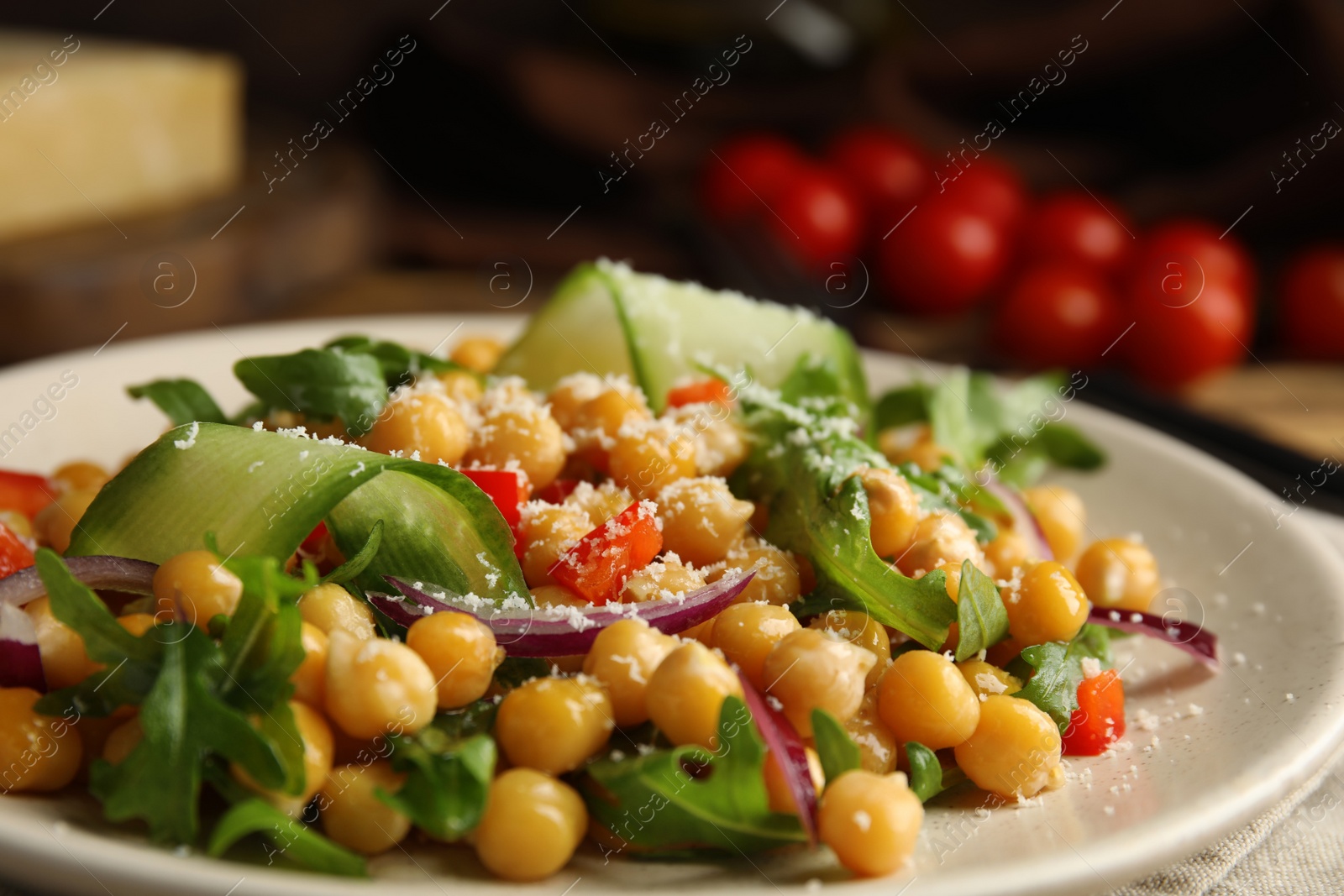 Photo of Plate with delicious fresh chickpea salad on table, closeup