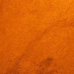 Image of Texture of stone surface painted in orange color as background