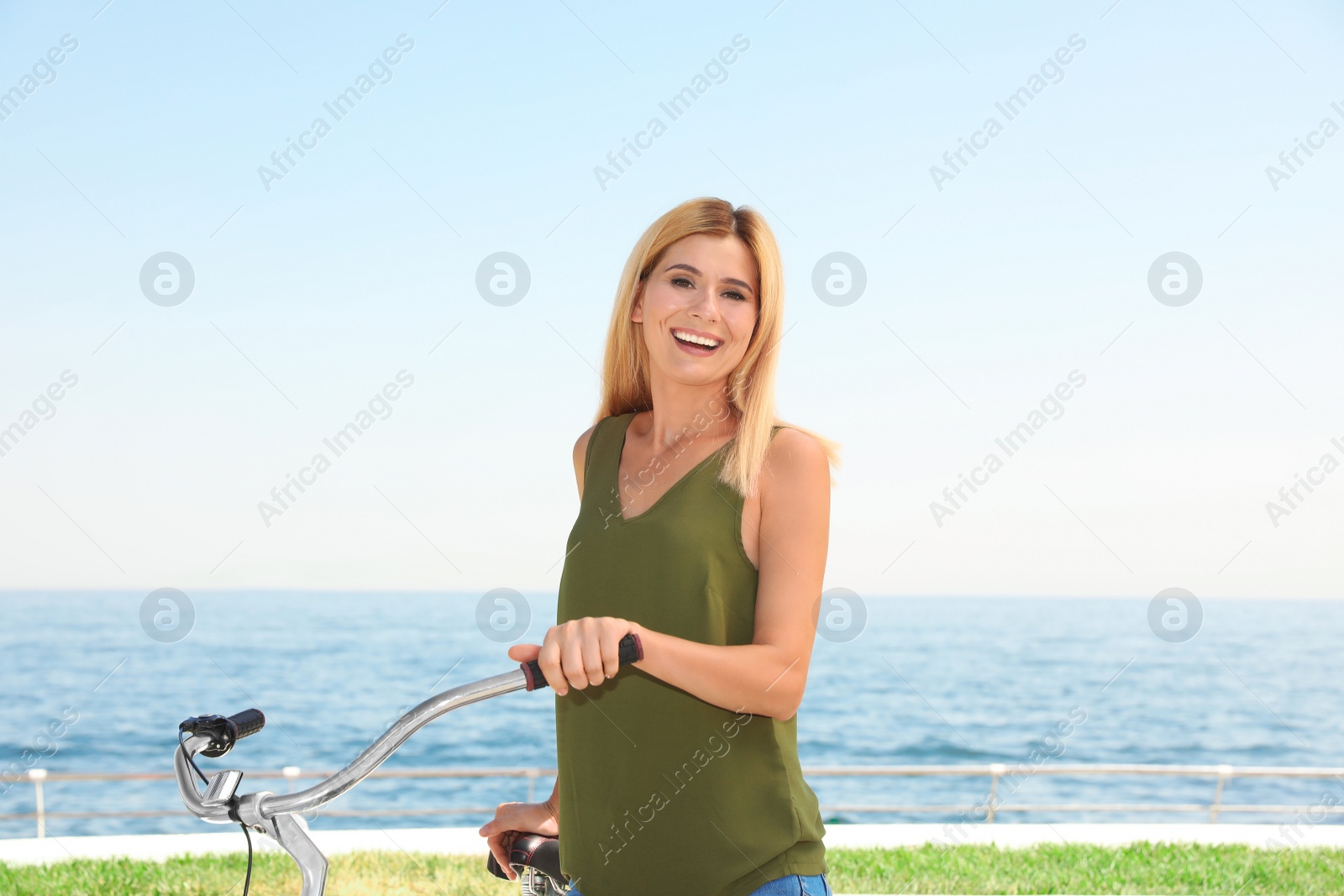 Photo of Attractive woman with bike near sea on sunny day