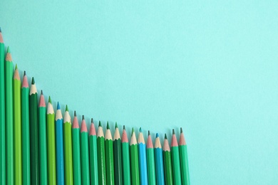 Photo of Different pencils on mint color background