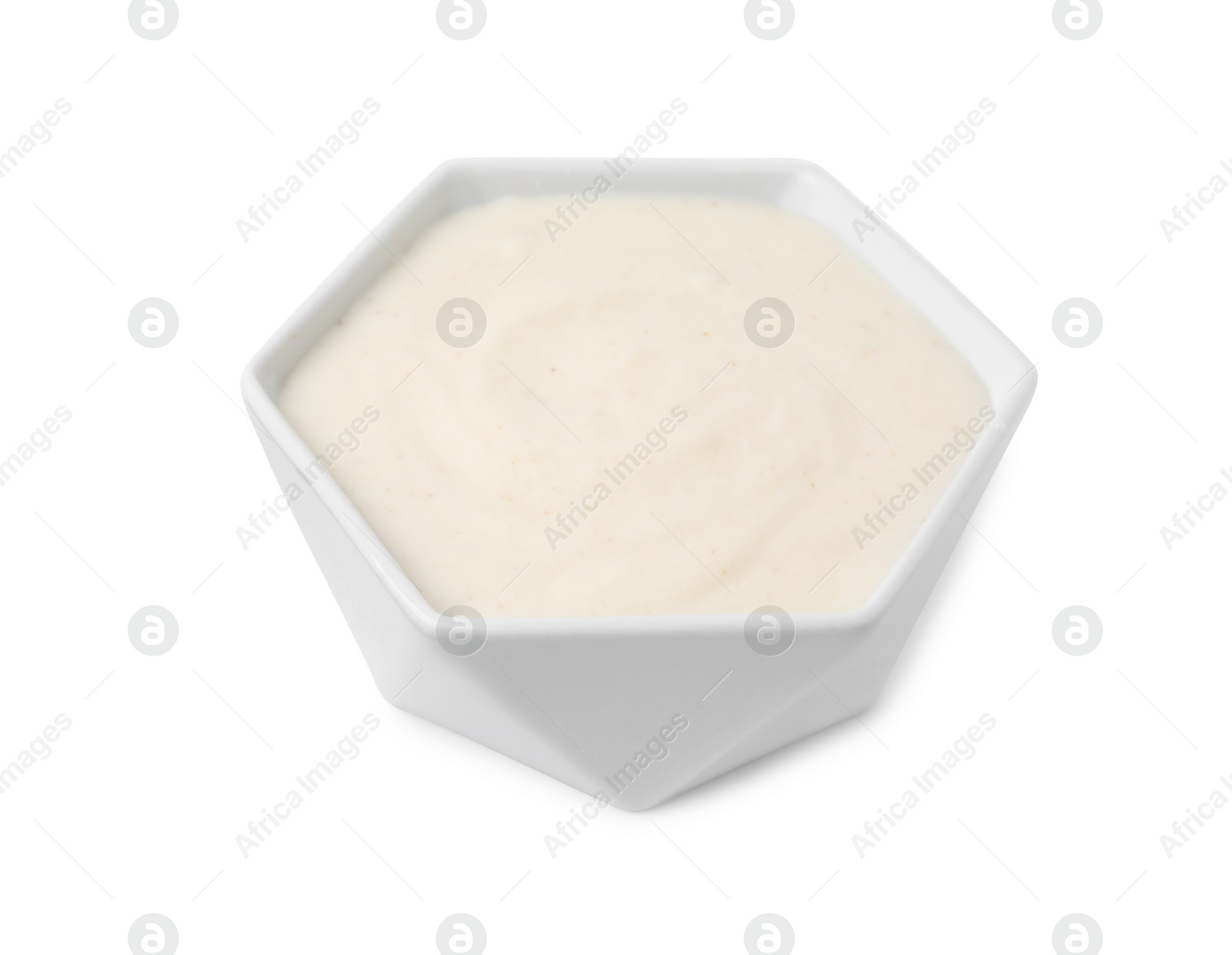 Photo of Bowl of delicious semolina pudding isolated on white
