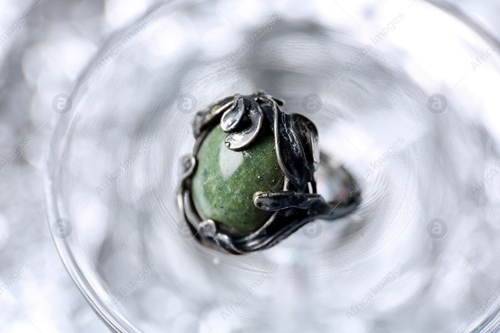 Photo of Beautiful silver ring with opal gemstone on textured surface, closeup