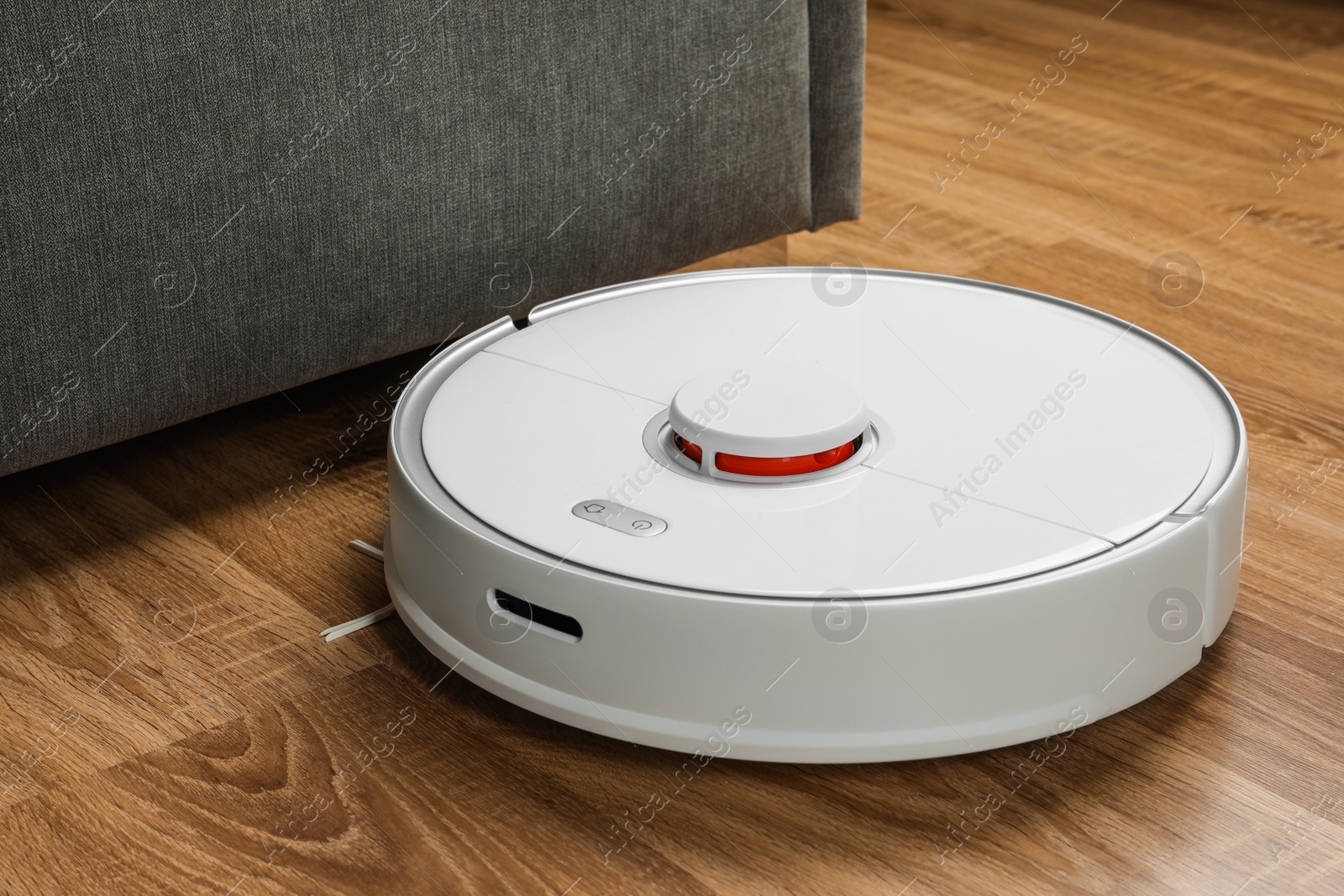 Photo of Robotic vacuum cleaner on wooden floor indoors