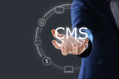 Image of CMS. Man using virtual screen, closeup. Scheme with icons on dark background