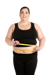 Overweight woman with measuring tape on white background