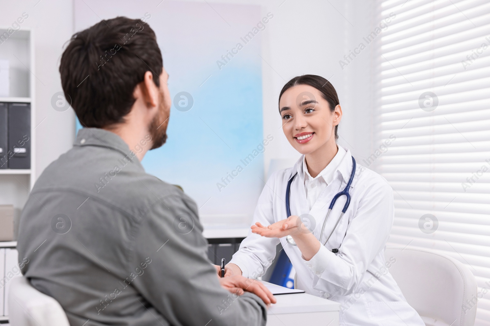 Photo of Doctor consulting patient during appointment in clinic