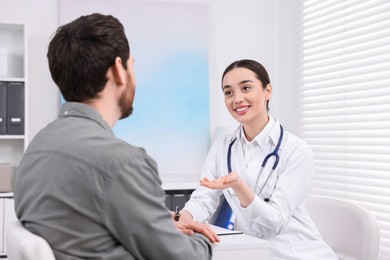 Photo of Doctor consulting patient during appointment in clinic