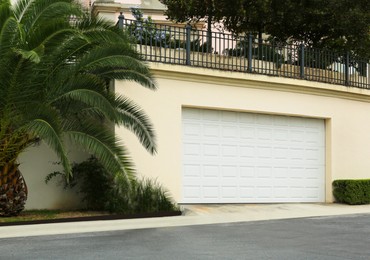 Building with white sectional garage door outdoors