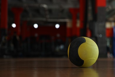 Photo of Medicine ball on floor in gym. Space for text