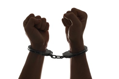 Photo of Freedom concept. Man with handcuffs on his hands against white background, closeup