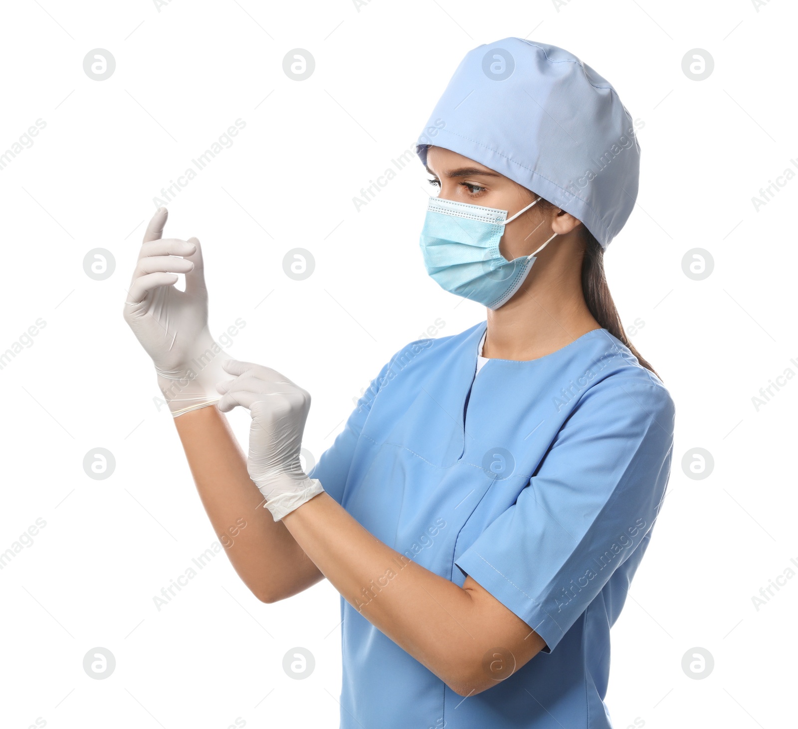 Photo of Doctor in protective mask and scrubs putting on medical gloves against white background