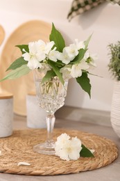 Beautiful jasmine flowers on wooden table indoors