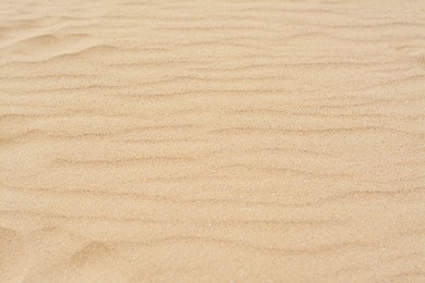 Dry beach sand with wave pattern as background