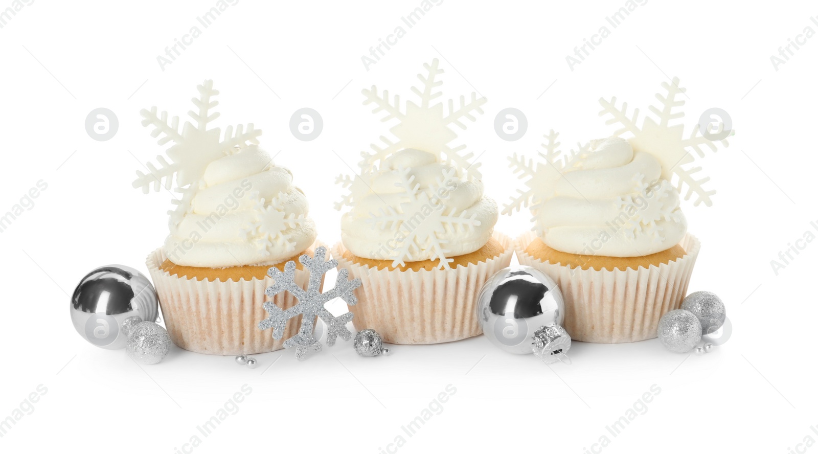 Photo of Tasty Christmas cupcakes with snowflakes and festive decor on white background