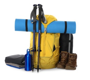 Photo of Trekking poles and other hiking equipment on white background