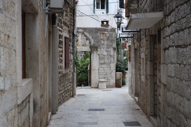Picturesque view of passage between old buildings in city