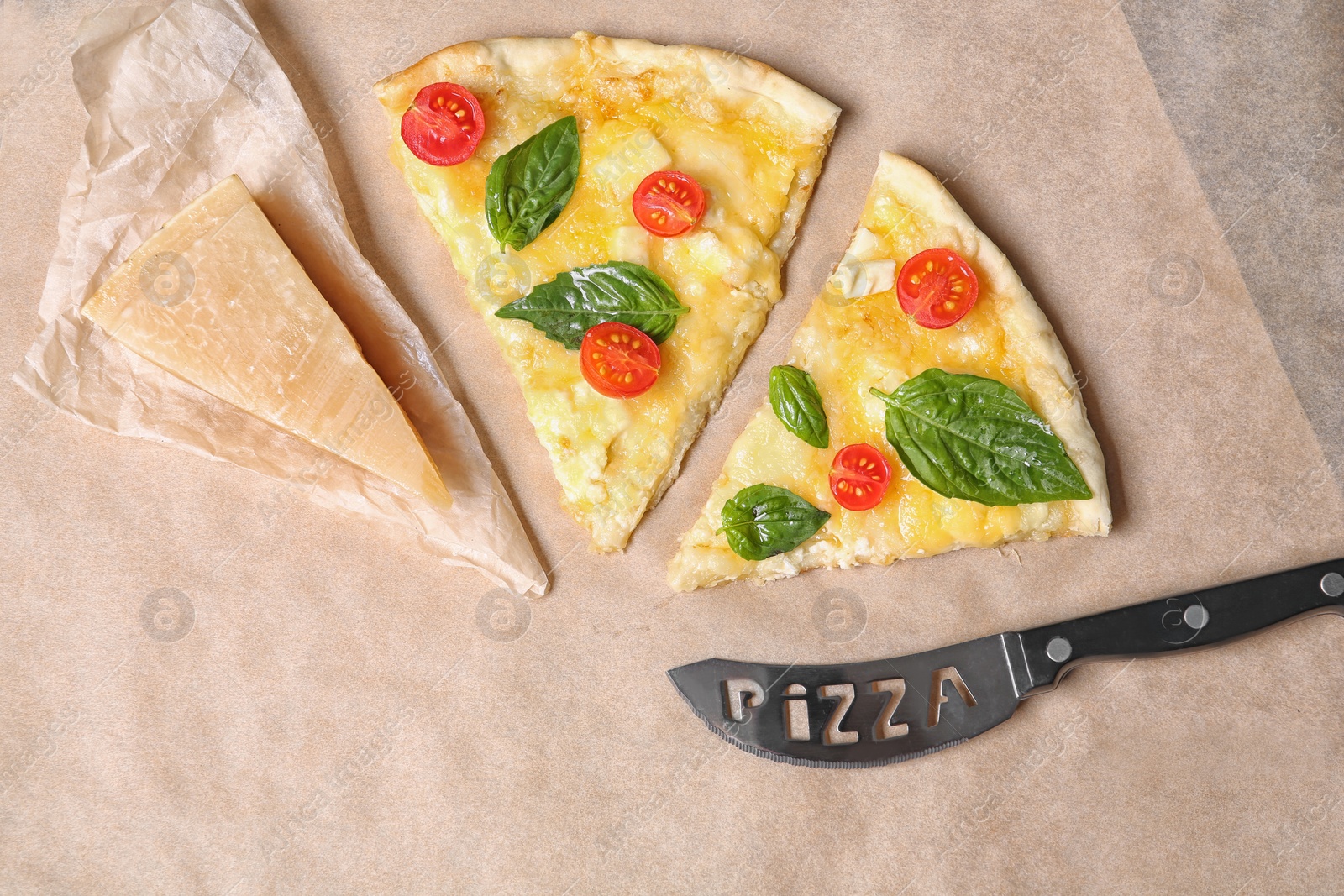 Photo of Flat lay composition with slices of tasty homemade pizza on parchment paper