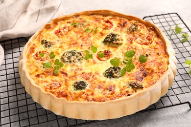 Photo of Delicious homemade quiche on light gray table
