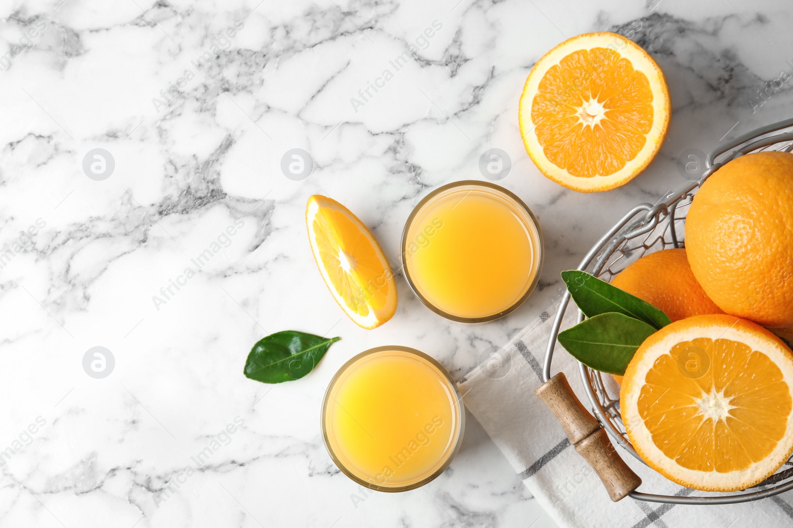 Photo of Flat lay composition with orange juice and fresh fruit on marble background, space for text