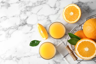 Photo of Flat lay composition with orange juice and fresh fruit on marble background, space for text