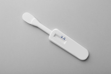 Photo of Disposable express test on light grey background, top view