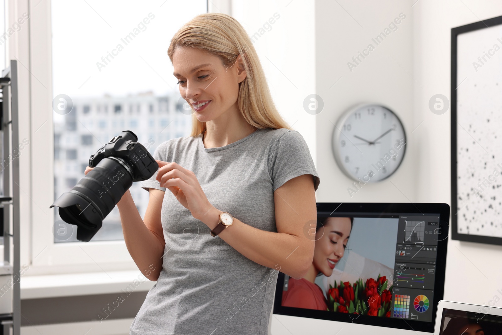 Photo of Professional photographer with modern digital camera in office