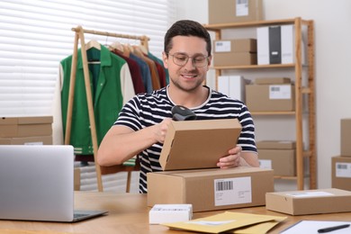 Seller with parcels working in office. Online store