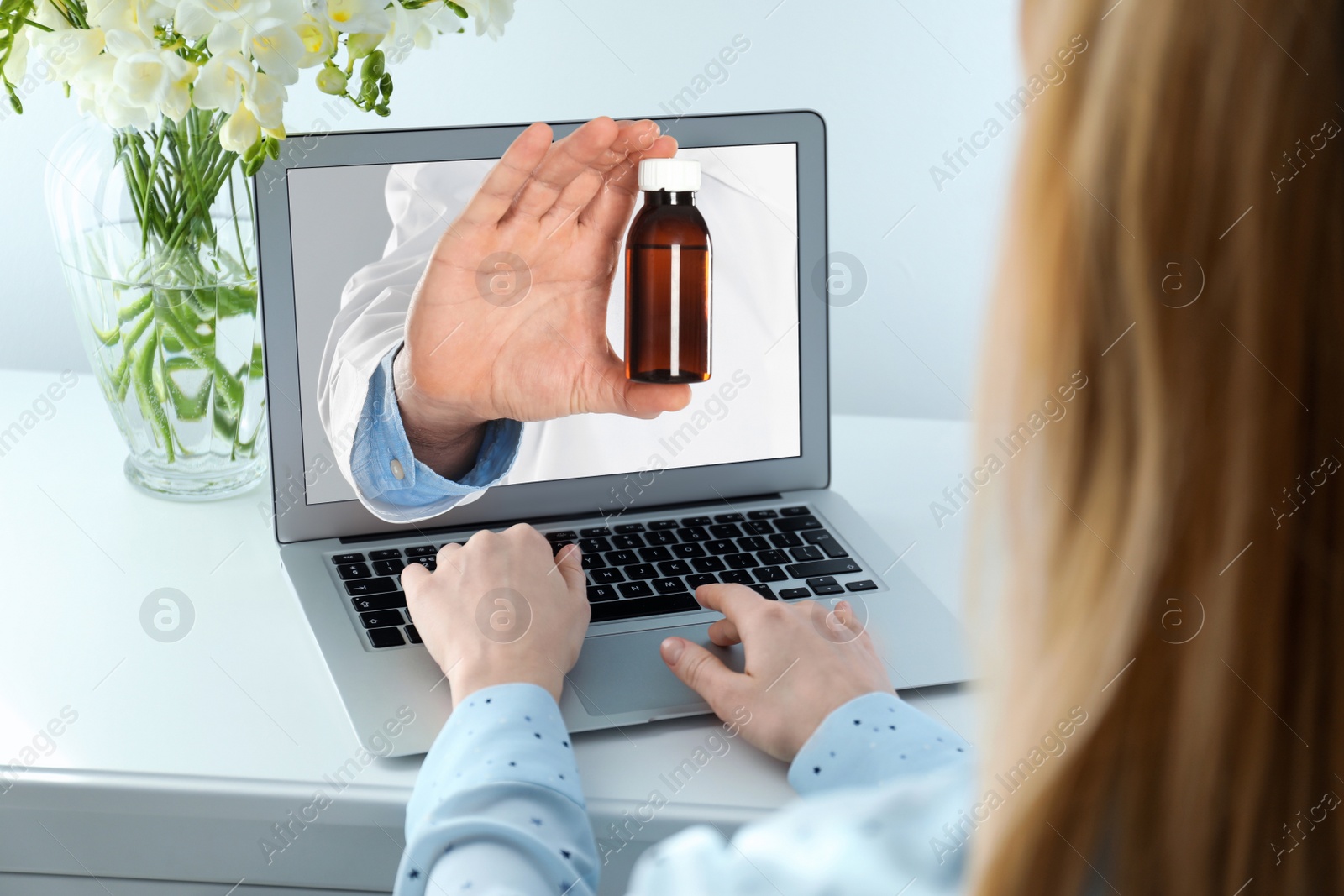 Image of Ordering medications online. Pharmacist giving pills from laptop screen