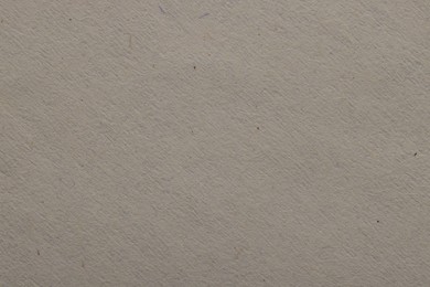 Photo of Texture of light grey paper sheet as background, top view