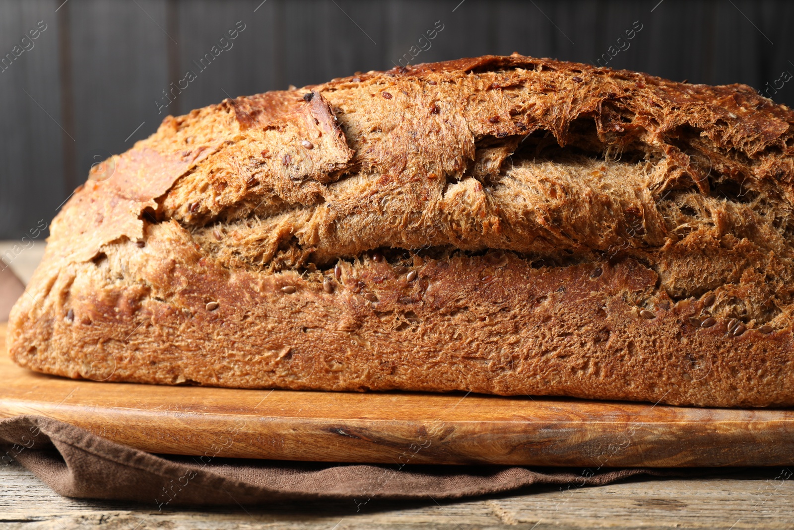 Photo of Freshly baked sourdough bread on wooden table, closeup