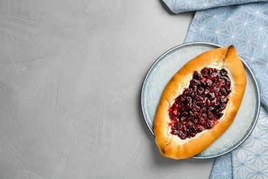 Photo of Delicious sweet cottage cheese pastry with cherry jam on grey table, top view. Space for text