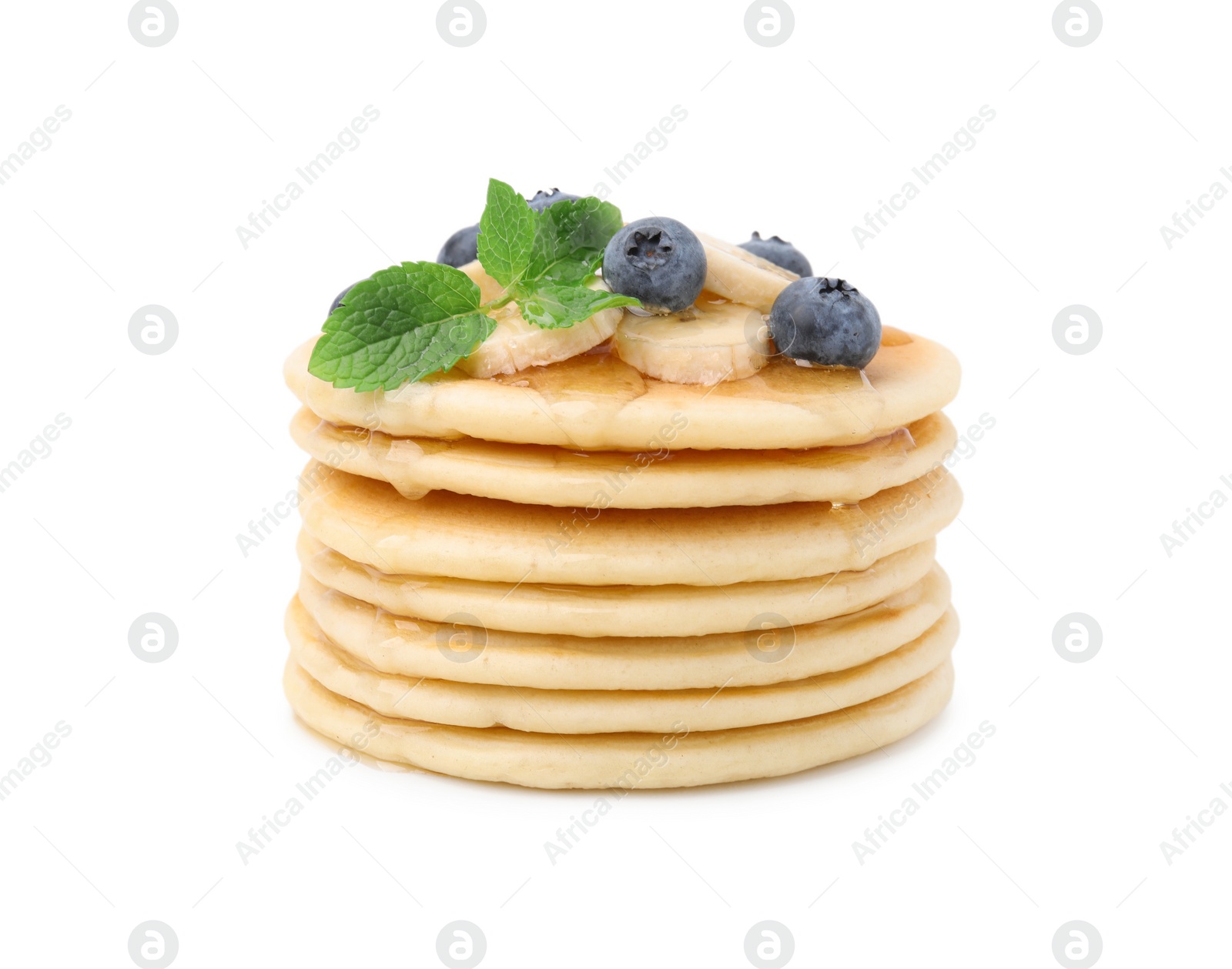 Photo of Delicious pancakes with banana slices, blueberries and mint isolated on white