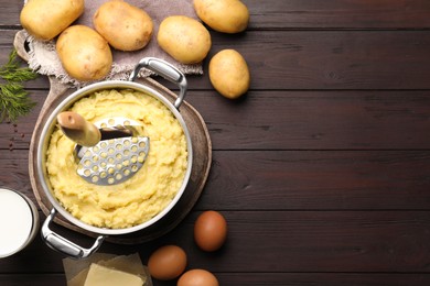 Photo of Flat lay composition with tasty mashed potatoes and ingredients on wooden table. Space for text