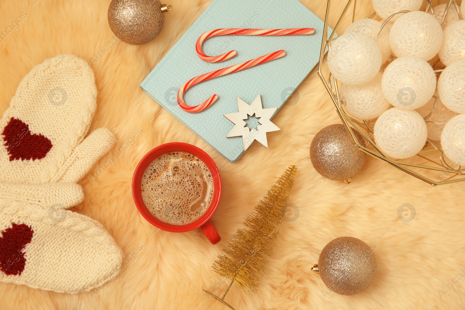 Photo of Flat lay composition with cup of hot winter drink on fluffy plaid. Cozy season