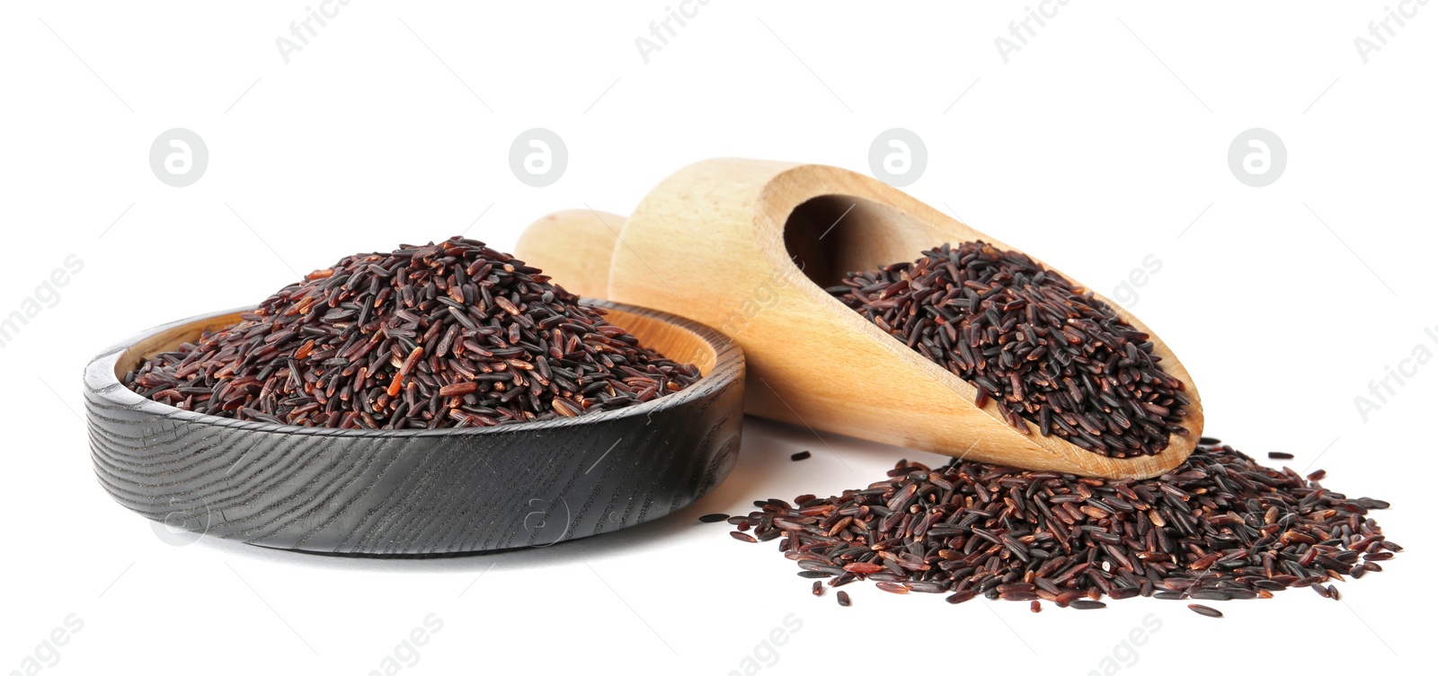 Photo of Plate and scoop with uncooked black rice on white background