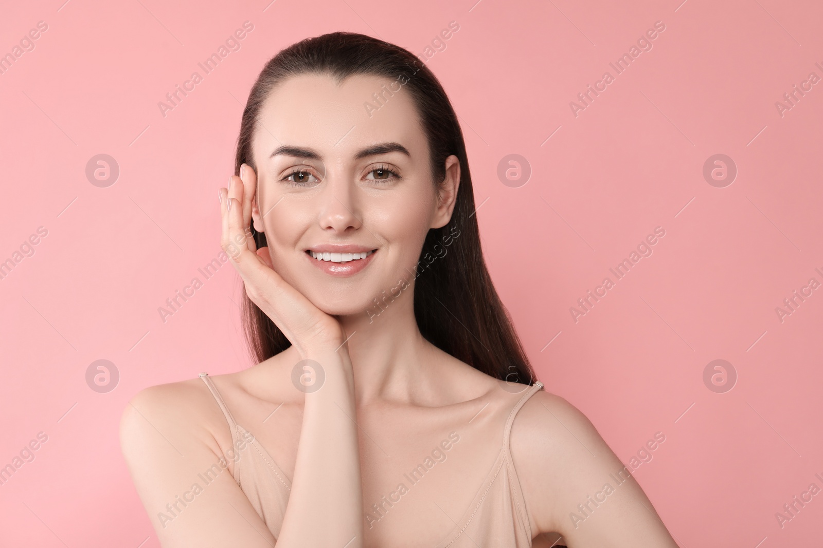 Photo of Portrait of beautiful young woman on pink background. Space for text