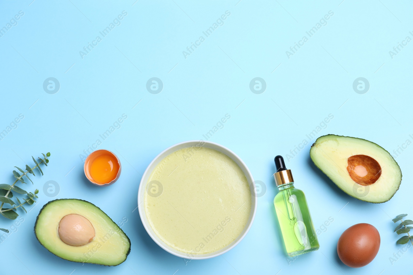 Photo of Homemade hair mask and ingredients on light blue background, flat lay. Space for text
