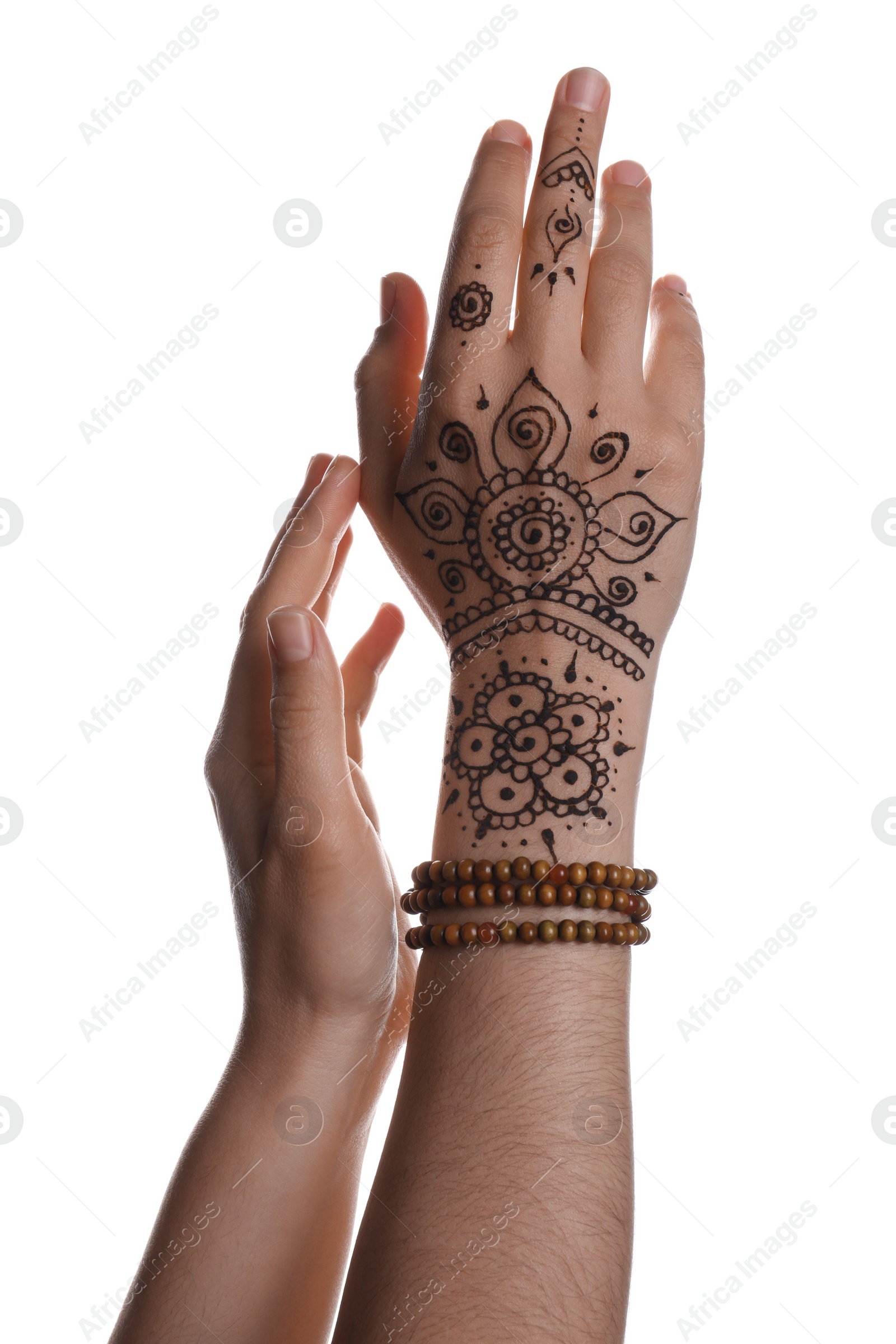 Photo of Woman with beautiful henna tattoo on hand against white background, closeup. Traditional mehndi