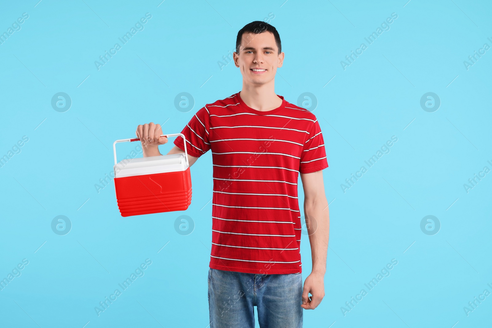 Photo of Man with cool box on light blue background