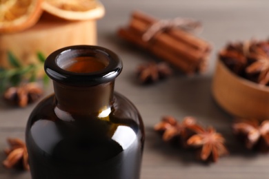 Photo of Anise essential oil in bottle on table, closeup. Space for text