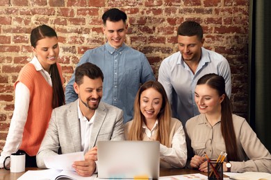 Team of employees working together in office