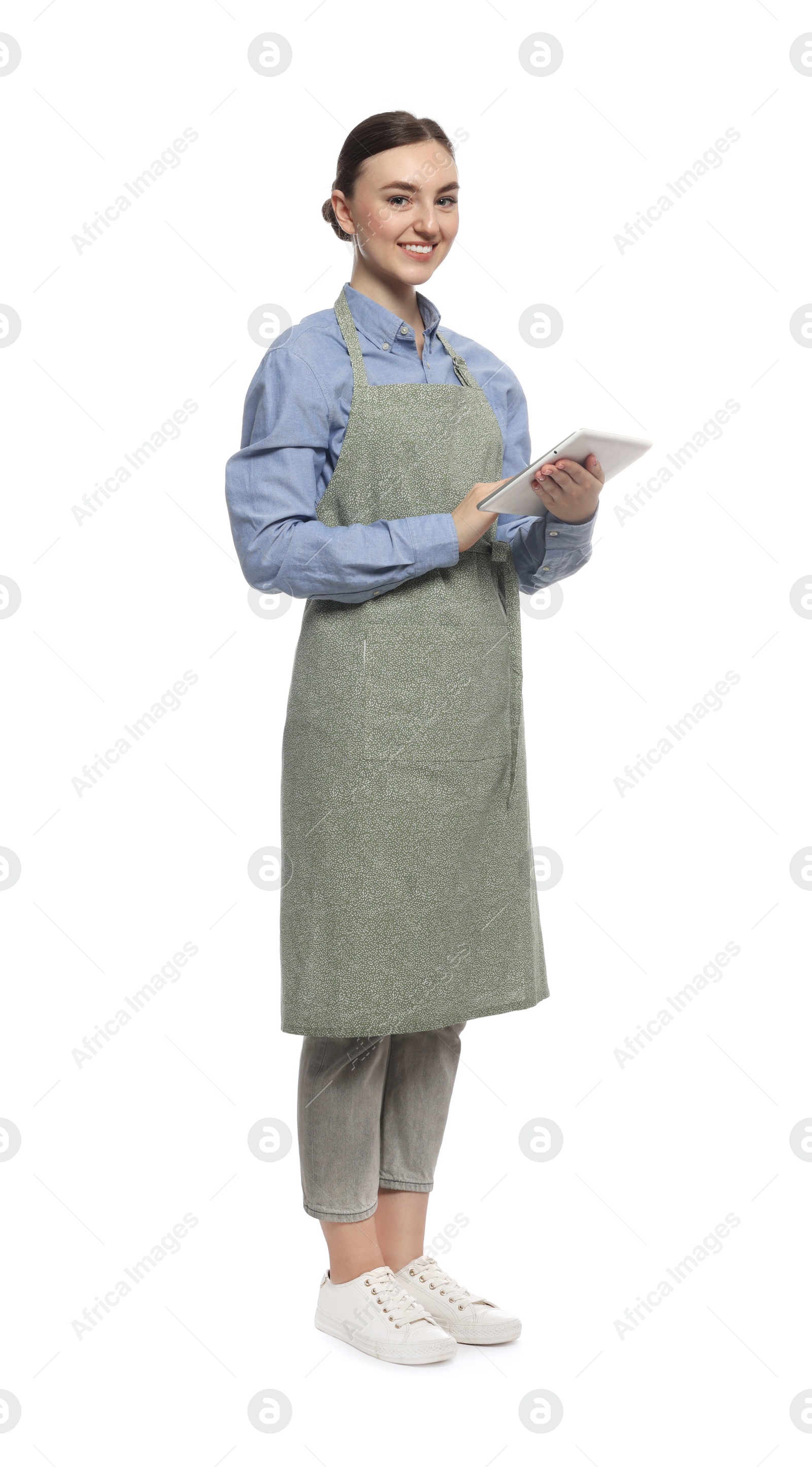 Photo of Beautiful young woman in clean apron with tablet on white background