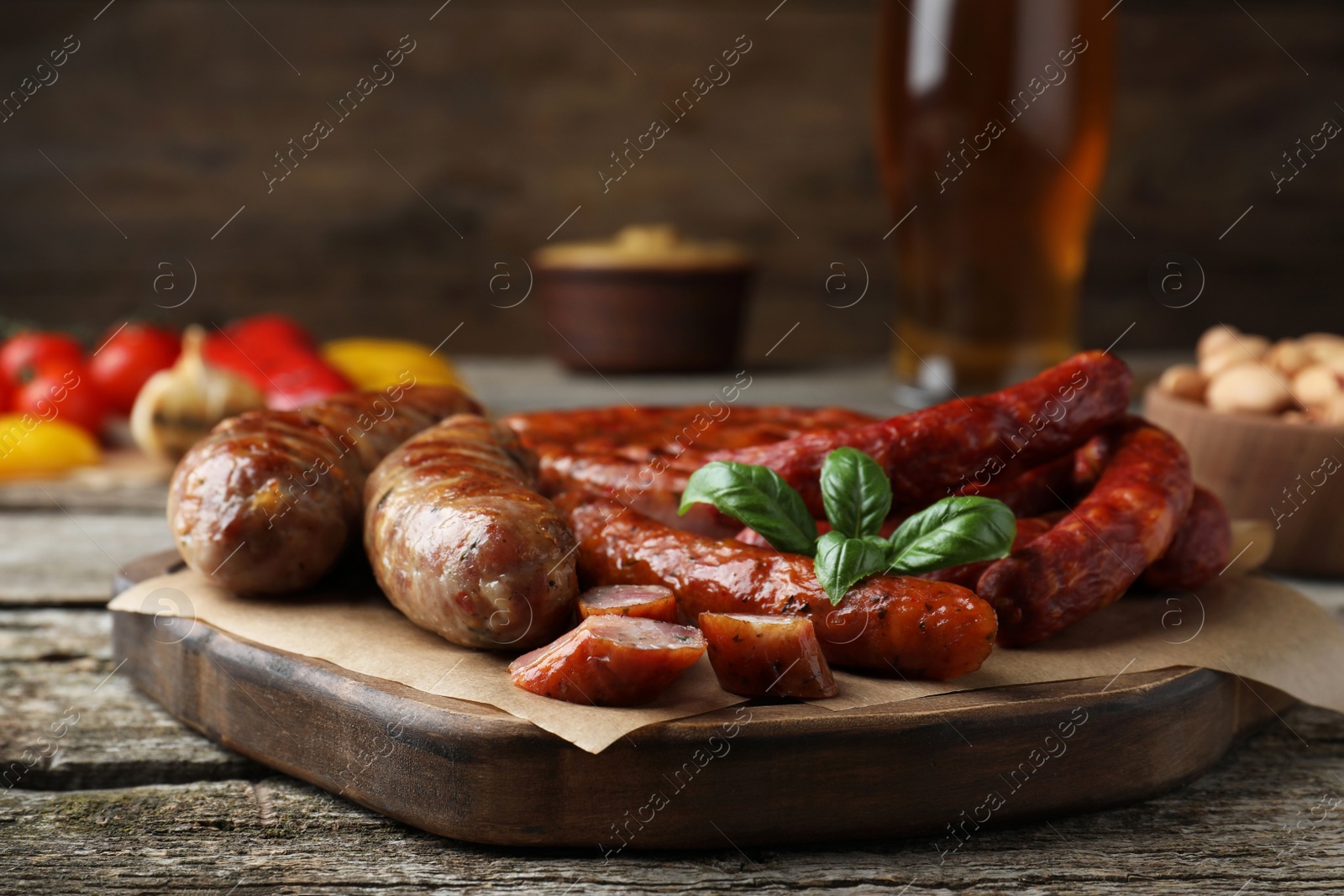 Photo of Set of different tasty snacks on wooden table, closeup view