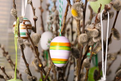 Beautiful willow branches with painted eggs indoors. Easter decor